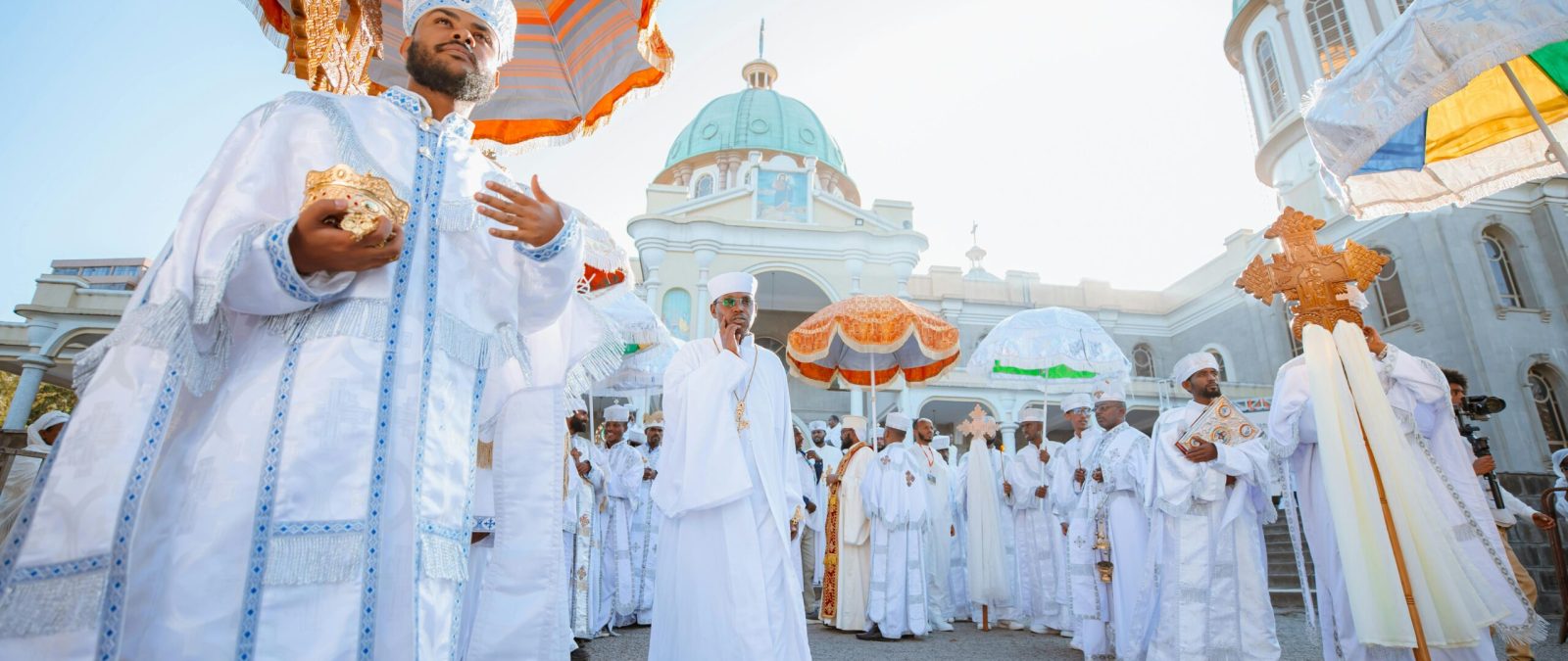 Orthodox religious procession at a church in Addis Ababa, Ethiopia, showcasing traditional attire and rituals.