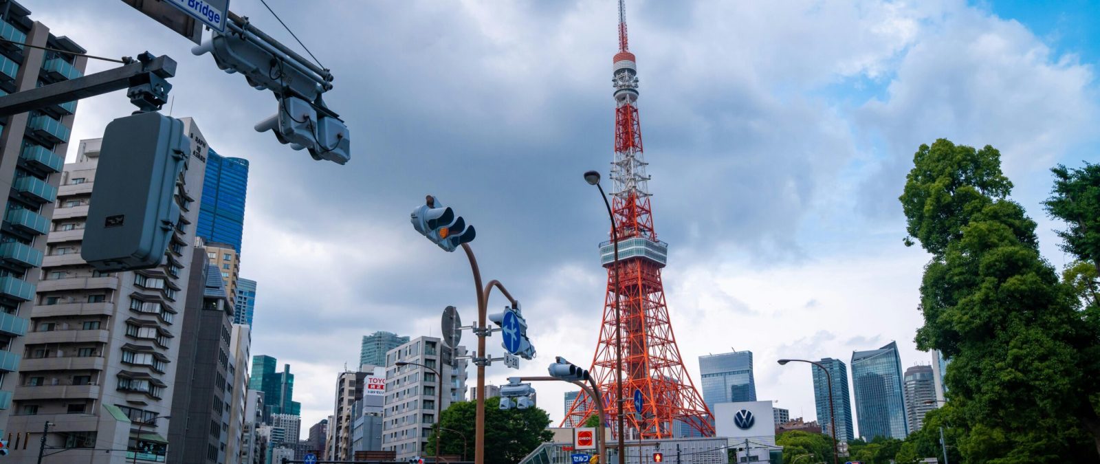 Vibrant cityscape featuring Tokyo Tower and Akabanebashi Bridge in Minato, Tokyo. Bright day with bustling urban life.
