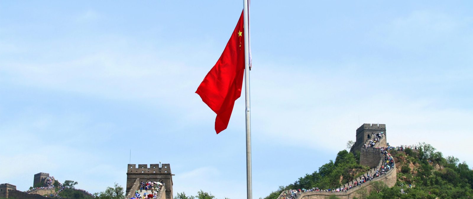 A scenic view of the Great Wall of China with the Chinese national flag in Beijing.