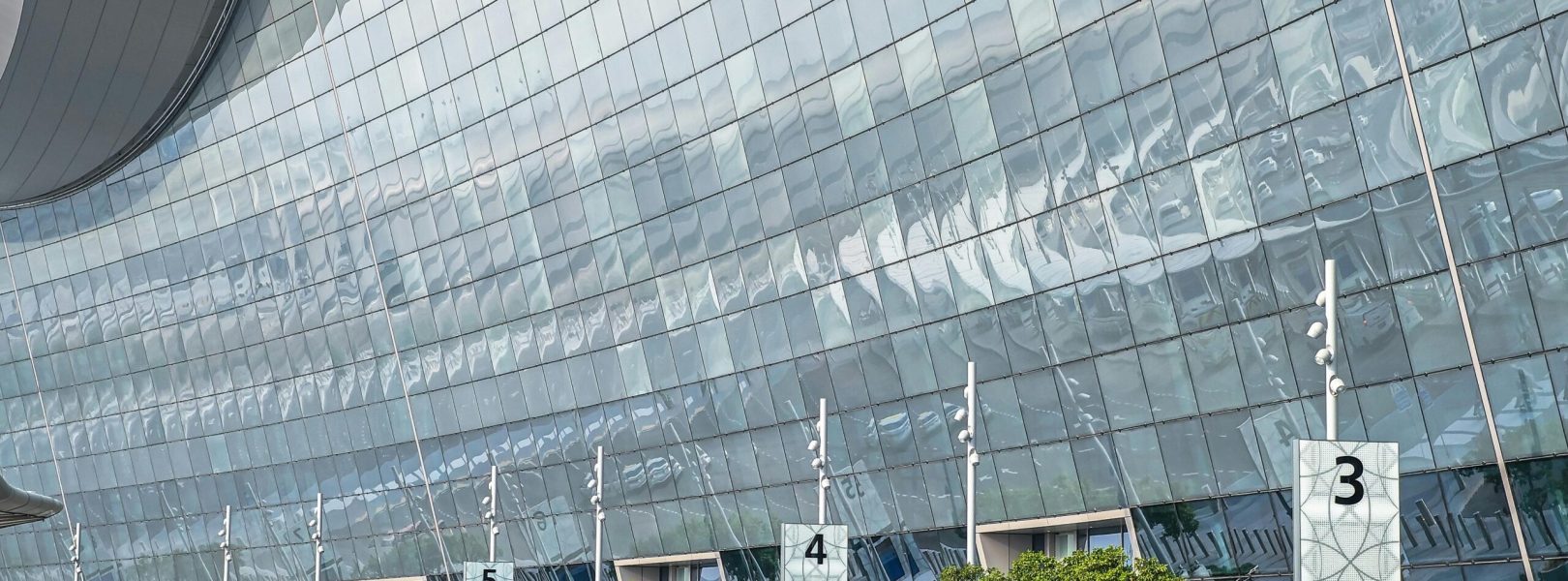 Stunning modern facade of an airport terminal in Abu Dhabi with reflective glass and contemporary design.