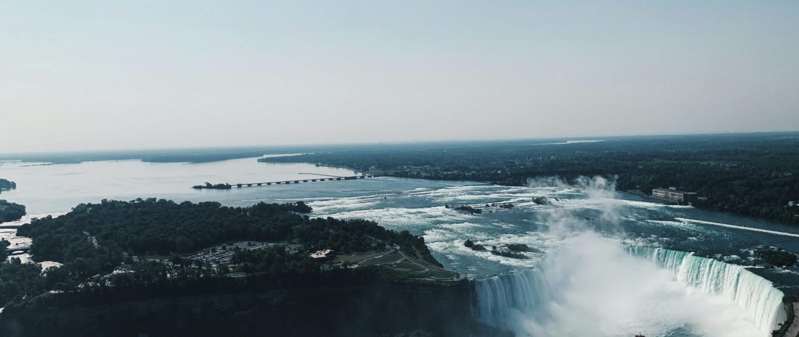 Stunning aerial shot of Niagara Falls showcasing the breathtaking landscape and clear sky.