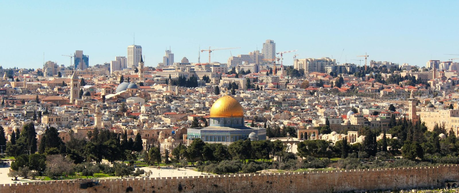 Stunning aerial shot of the Dome of the Rock and Jerusalem skyline, capturing the historic and urban landscape.